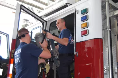 Firefighters unload equipment at new station.